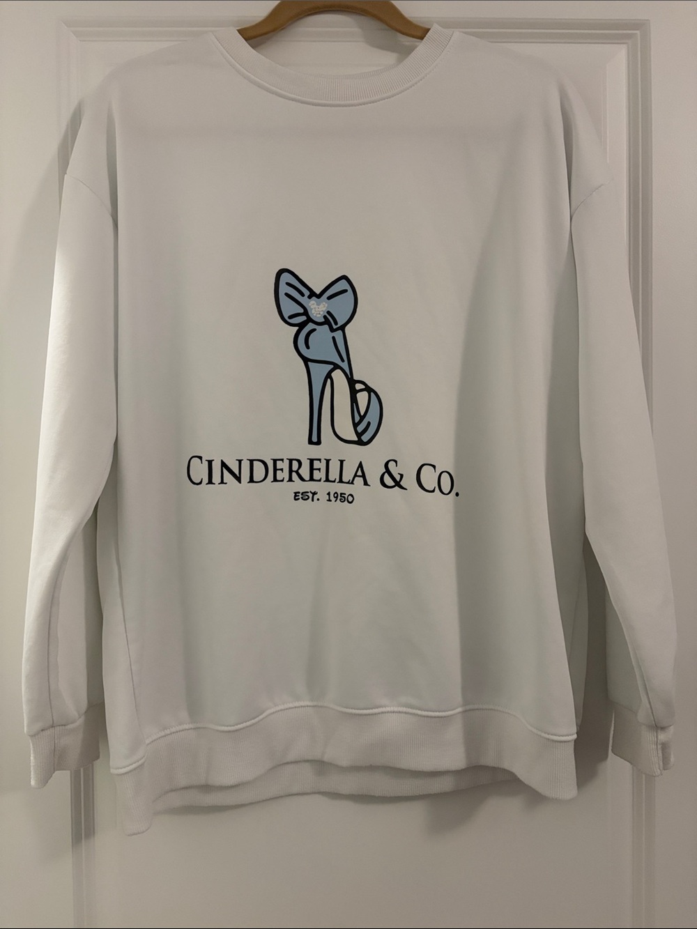 Disney Themed Cinderella & Co. White Graphic Sweatshirt with Blue Heel Logo